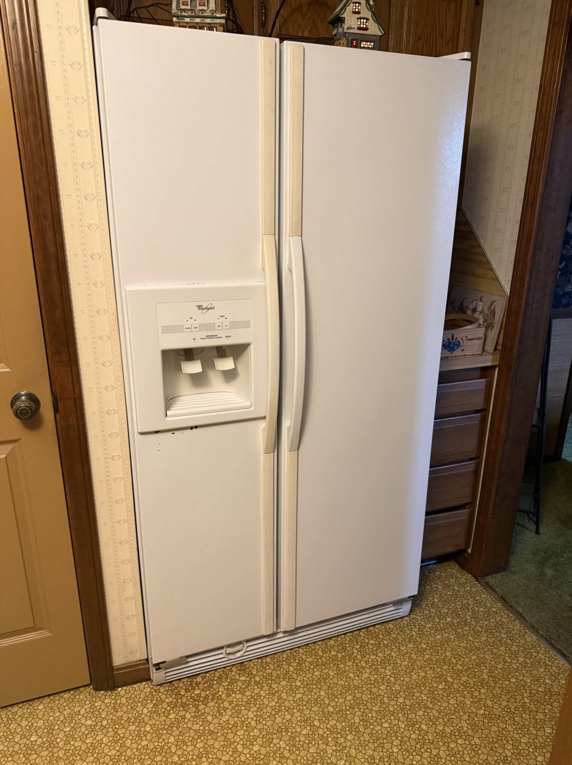 Whirlpool ED25RFXFW01 refrigerator repair showing replaced thermostat.