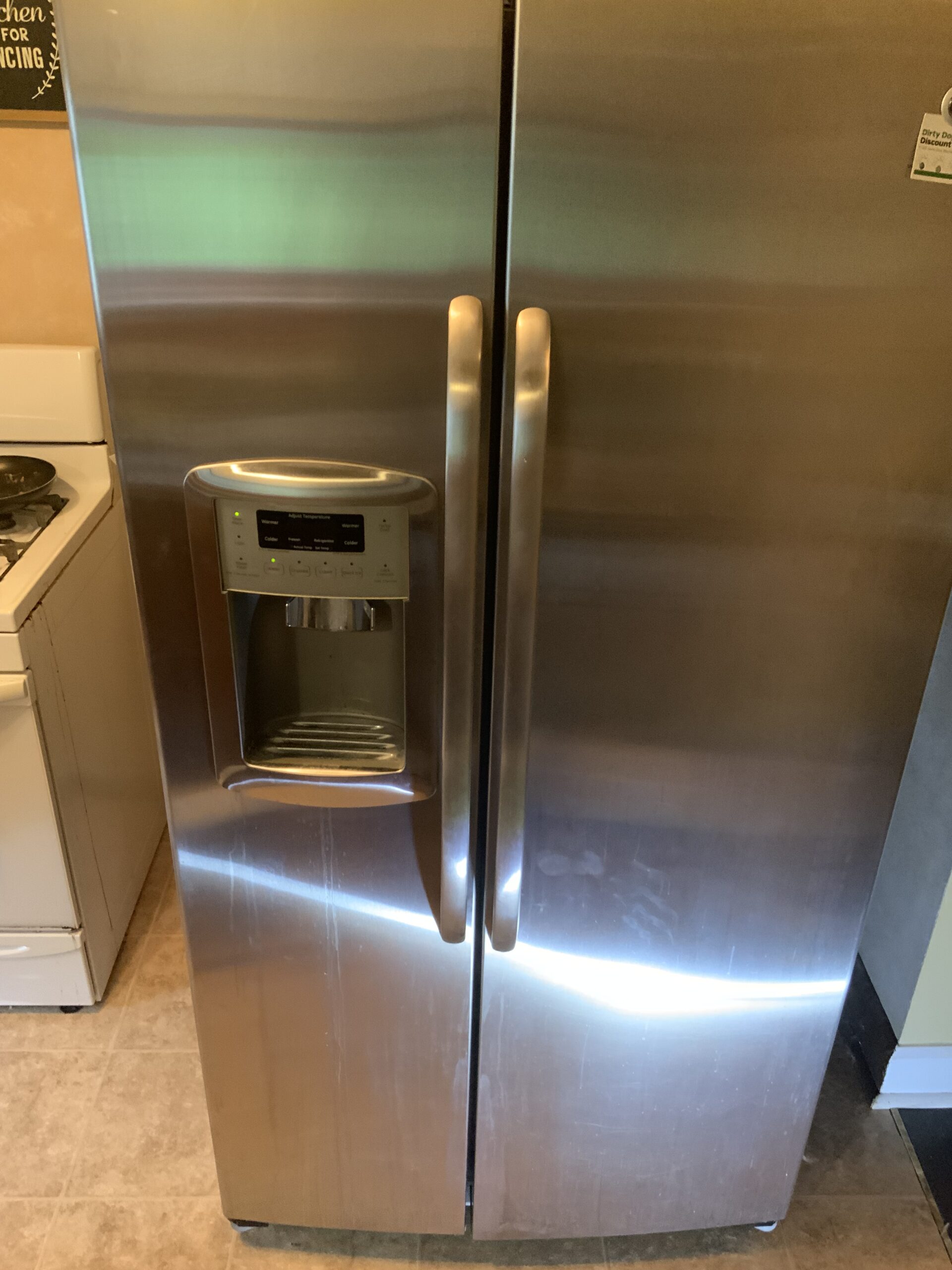 Front view of GE refrigerator model GSHS5PGXAESS during repair in Canton, OH.