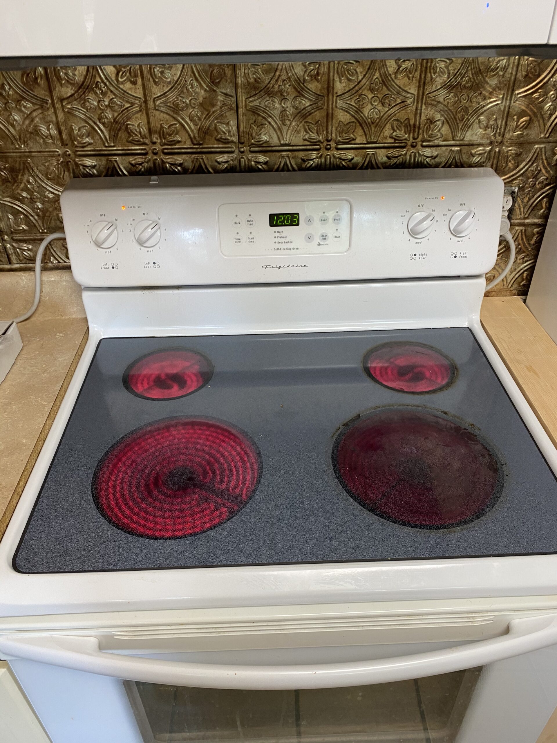 Frigidaire FEF366ESH oven with the front left burner repaired in Alliance, OH