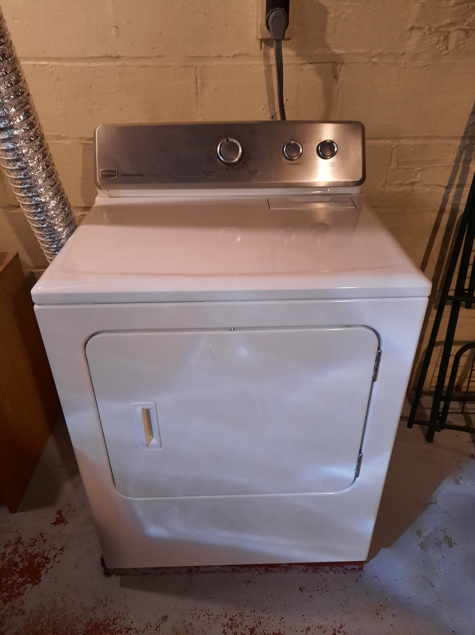 Appliance technician repairing a Maytag dryer, model MEDC300BW0, in Alliance, Ohio.