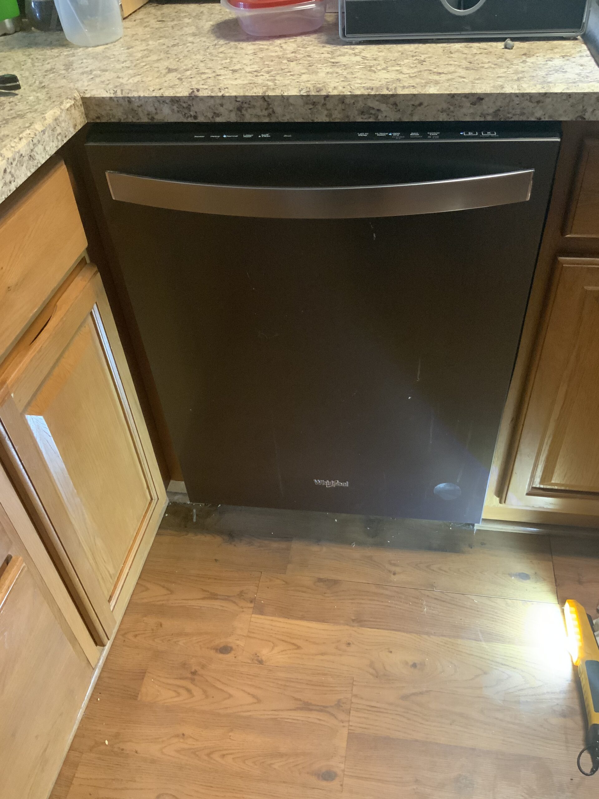 A technician from Louisville Appliance Repair working on a Whirlpool WDT970SAHV0 dishwasher.
