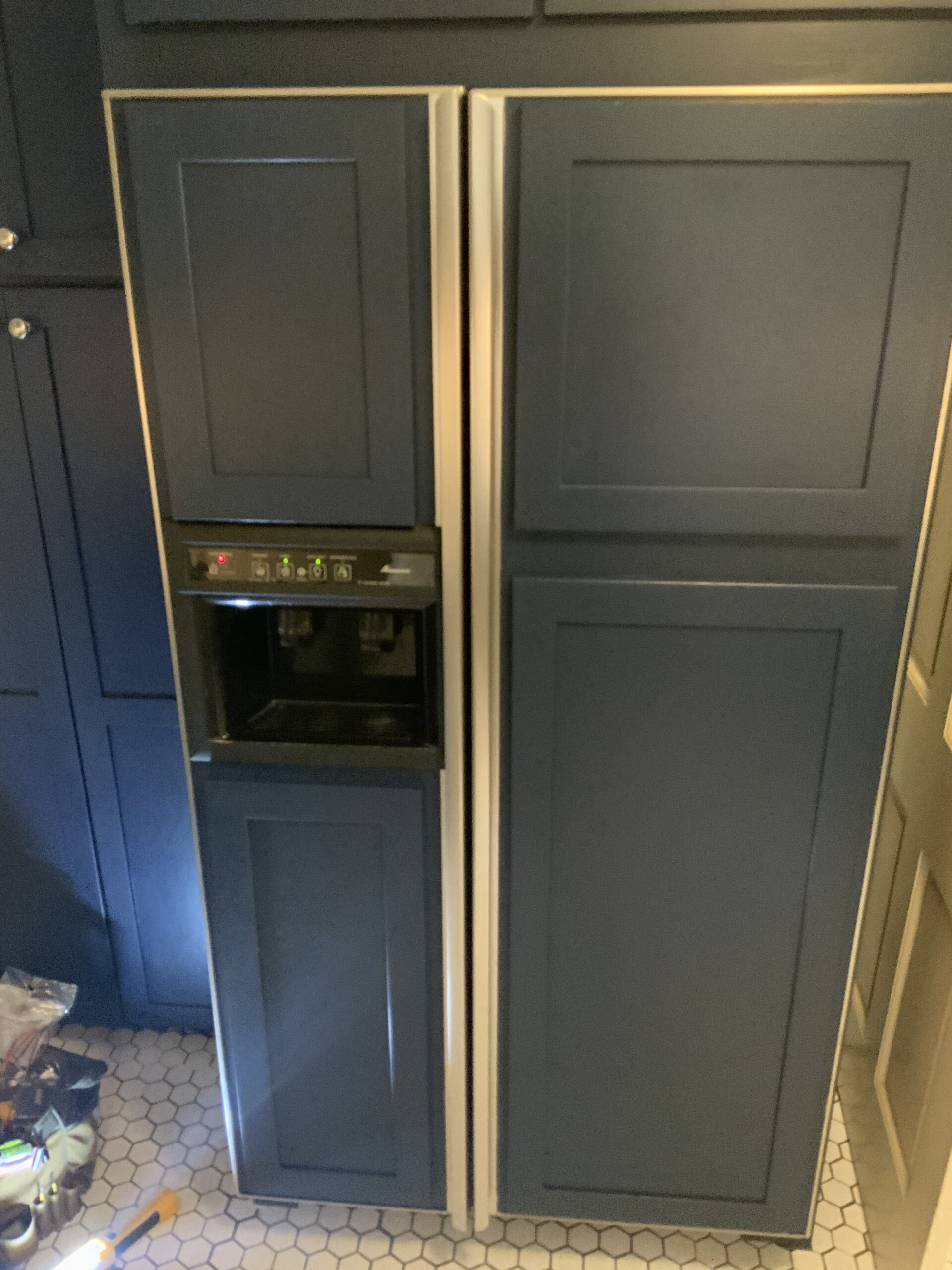 Technician replaces evaporator fan motor in Amana Refrigerator ARS9169AS.