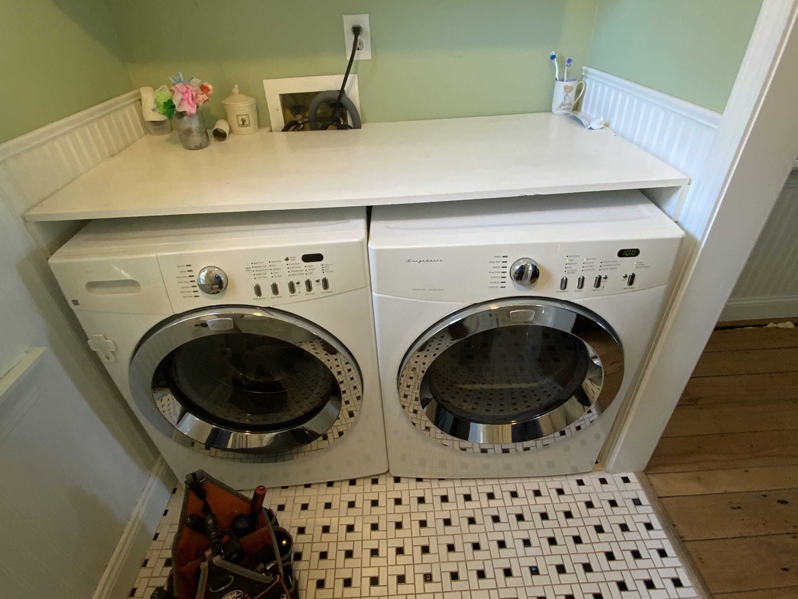 Technician repairing Frigidaire dryer AEQ6700FS0 control board and exhaust vent in Homeworth, Ohio.