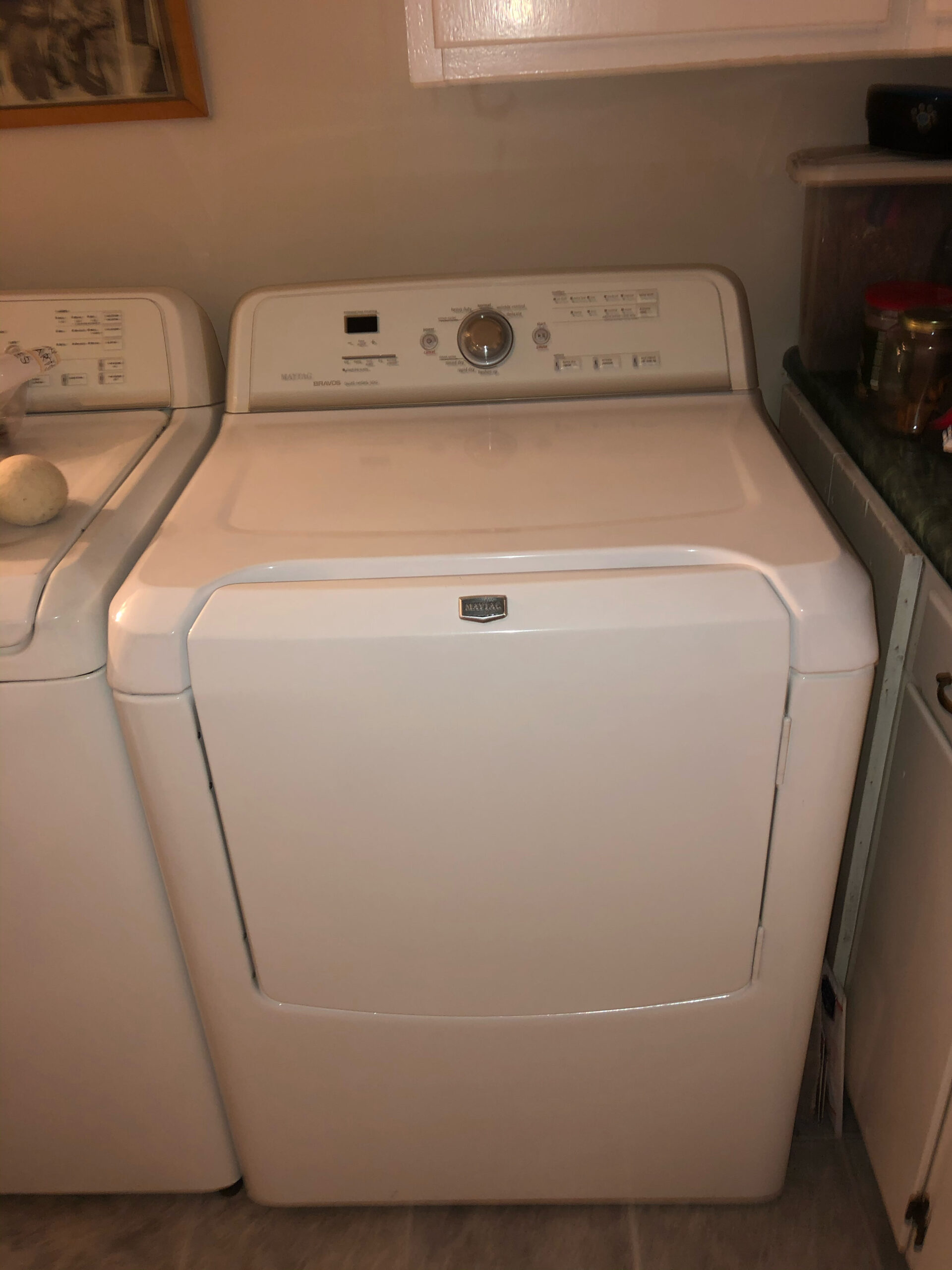 Samuel Willhite repairing a Maytag MEDB200VQ0 Dryer, focusing on support rollers and idler pulley.