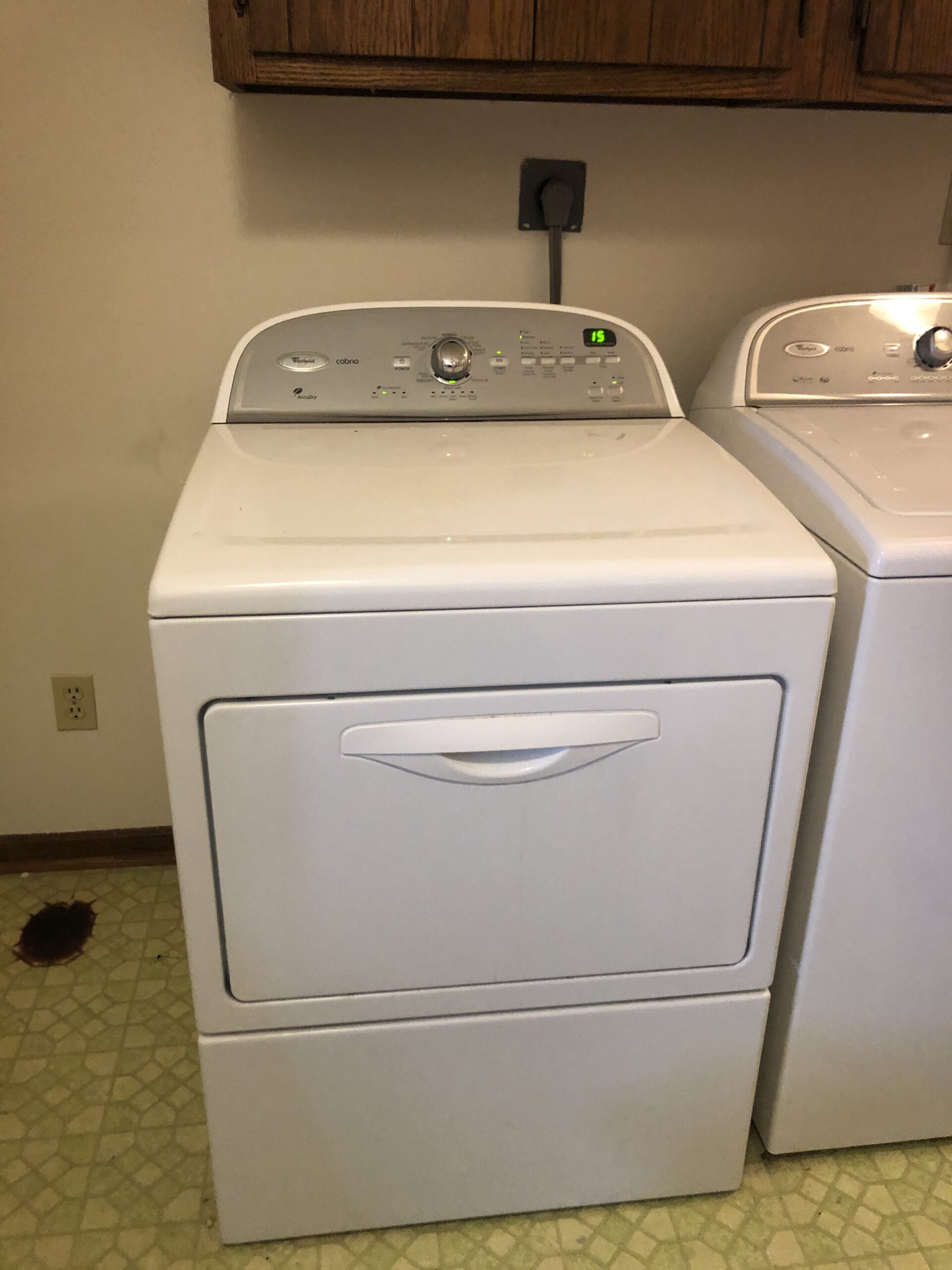 Technician Samuel Willhite repairs a Whirlpool dryer model WED5610XW1.