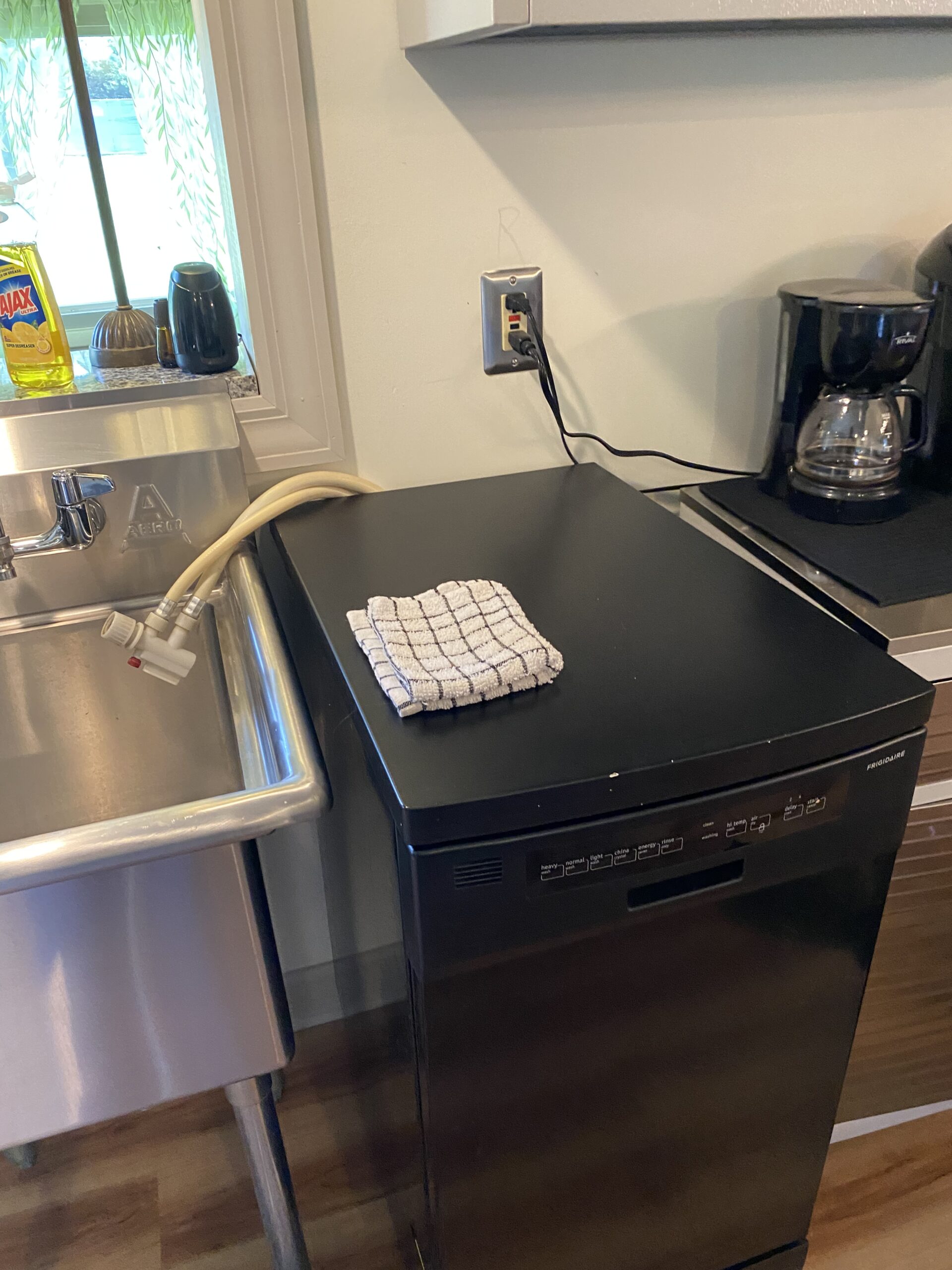 Technician repairing Frigidaire FFPD1821MB1B dishwasher latch in Canton, Ohio.