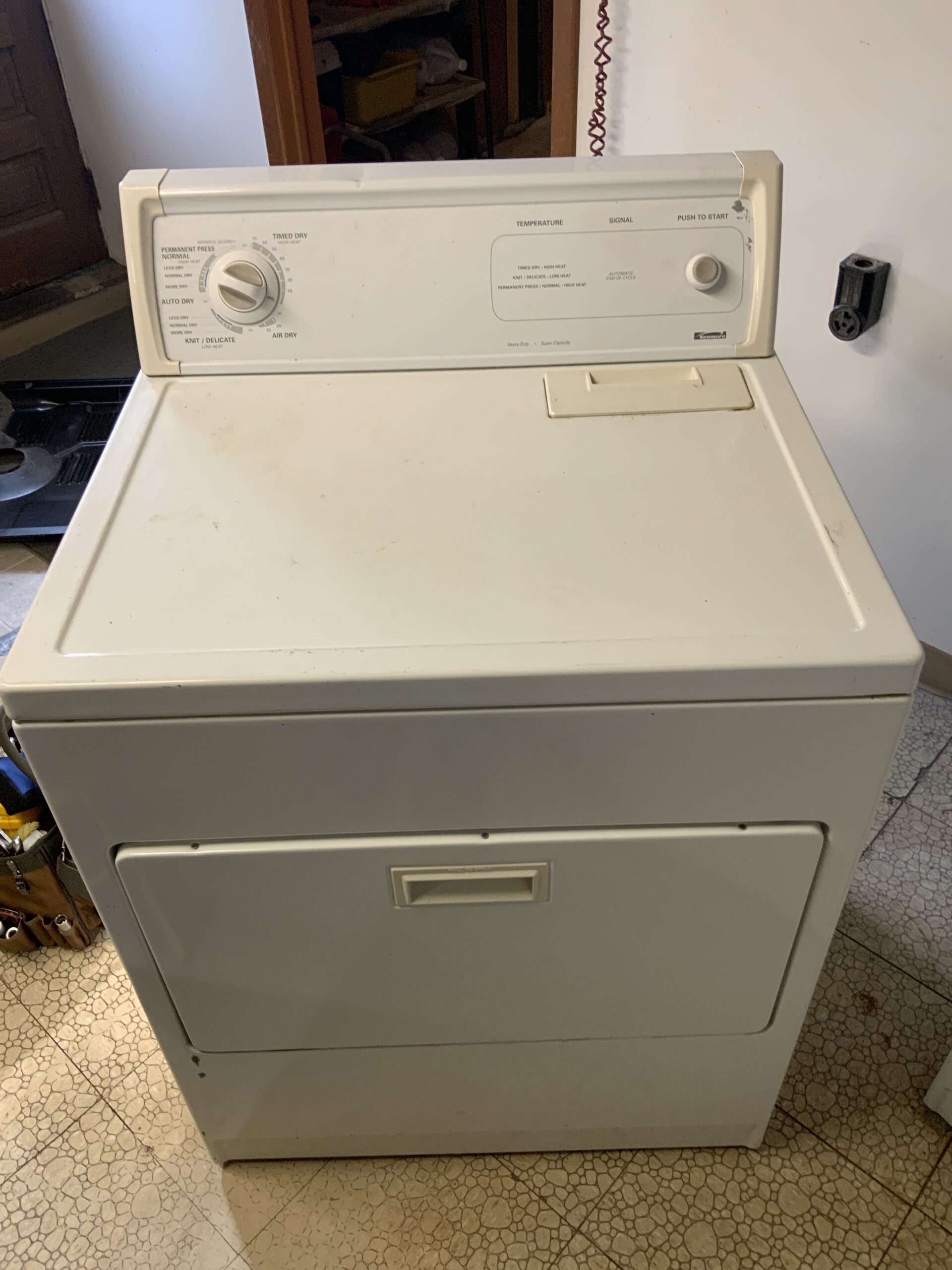 Samuel Willhite repairing Kenmore oven and dryer at East Sparta home; new burners and heat element installed.